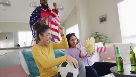 diverse female and male friends watching tv celebrating american victory in slow motion