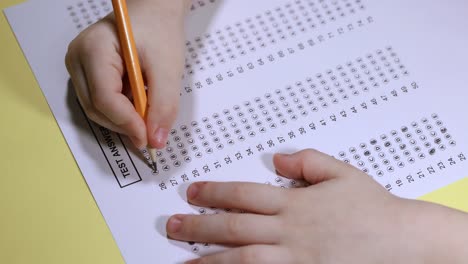 exam. filling in the test with a pencil. slow motion