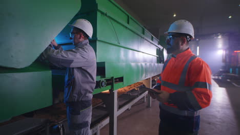 industrial workers inspecting machinery