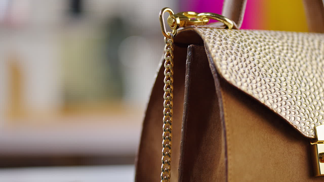 Close-up of a stylish gold handbag