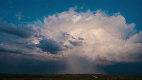 dramatic storm clouds with rain shaft over a rural landscape
