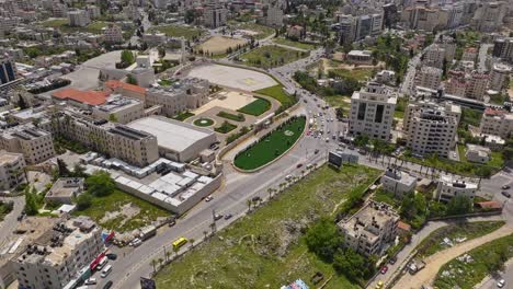 Aerial-View-Of-Arafat-Mausoleum-With-Traffic-In-The-City-Of-Ramallah,-Palestine