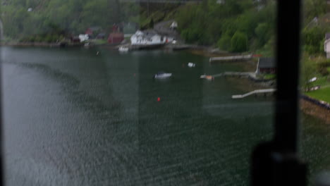 hand-held shot of seafront apartments with docks and boats in vestland, norway