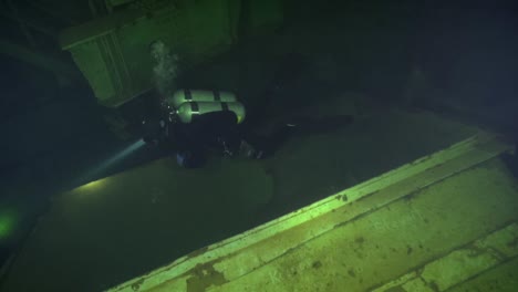 Backmount-tech-diver-explores-blast-deflector-in-flooded-nuclear-missile-silo