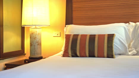 Pan-from-glass-divider-across-hotel-bed
