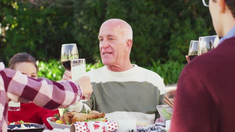 Happy-caucasian-family-having-dinner-in-garden