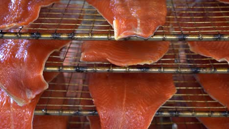 Extreme-closeup-of-cold-smoked-rainbow-trout-fillets-on-grate---Pan-down---Norway