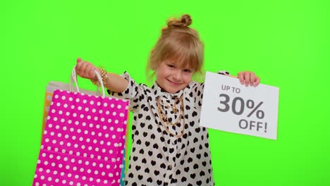 Kid-child-girl-showing-shopping-bags-and-Up-To-30-Percent-Off-inscriptions-banner-text,-Black-Friday