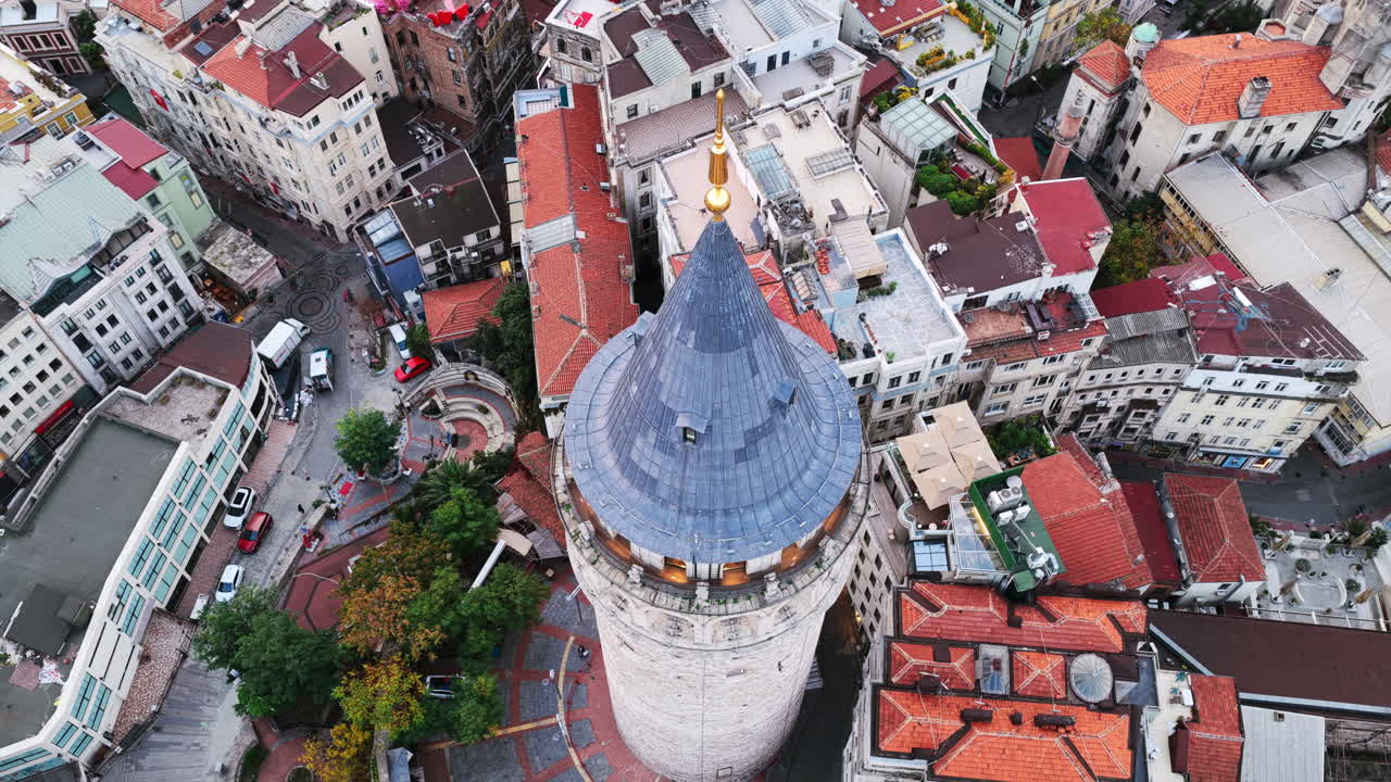 The iconic Galata Tower rises above surrounding buildings, offering a glimpse into Istanbul’s mix of history and urban development