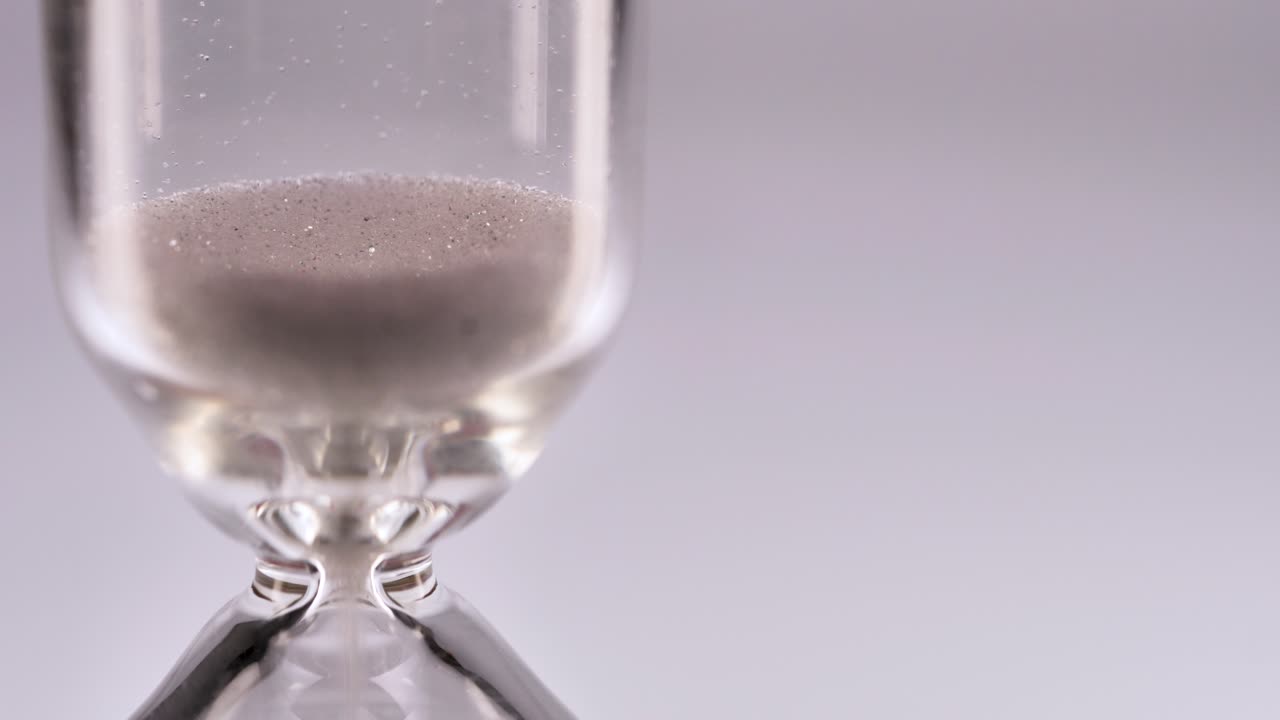 White sand running in an hourglass