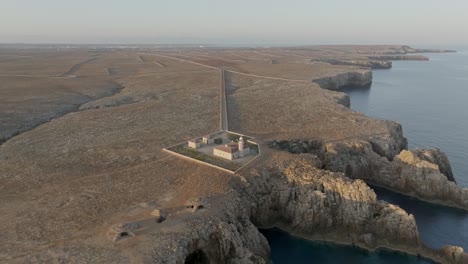 zoomed-out view of the cliffs at the faro de punta nati lighthouse