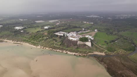 Fortress-of-Cacela-Velha-in-Portugal,-during-foggy-day,-Aerial-orbit-shot