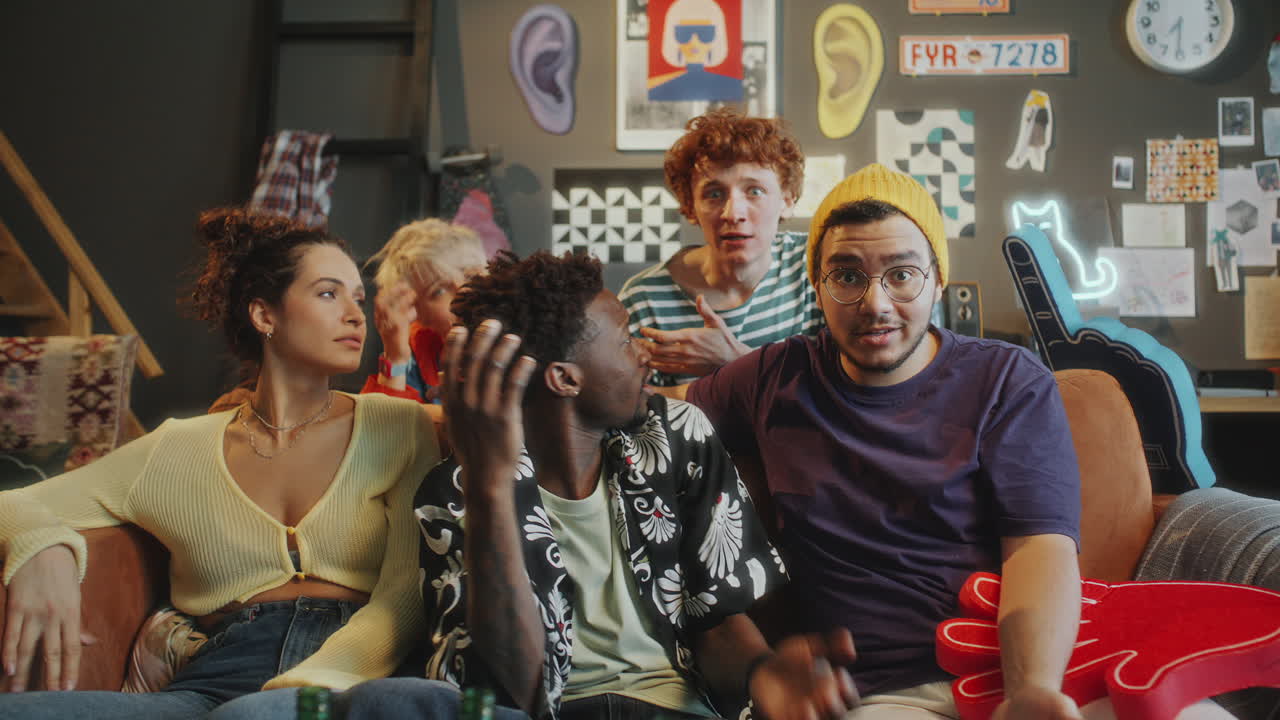 Nervous Friends Watching Sports on TV and Discussing Tense Game Moment