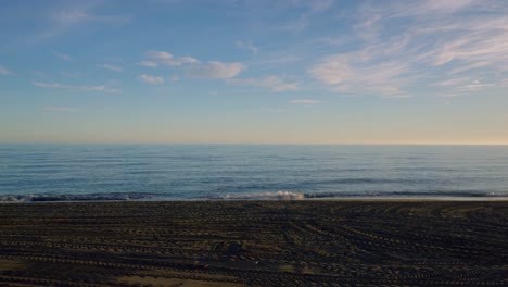 Sandy-beach-timelapse-with-scattered-clouds