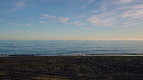 Sandy beach timelapse with scattered clouds