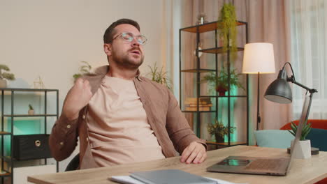 sad caucasian young man freelancer looks pensive thinks over life concerns sitting at desk at home