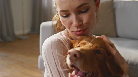 caring girl love dog caressing fluffy head at home close up. woman stroking pet
