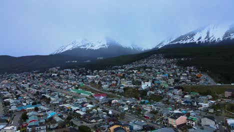 Disparo-De-Un-Dron-Volando-Sobre-Ushuaia,-Argentina,-Hacia-Las-Montañas-De-Los-Andes-Cubiertas-De-Nieve.