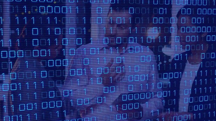 Animation of binary code over diverse female and male coworkers in office