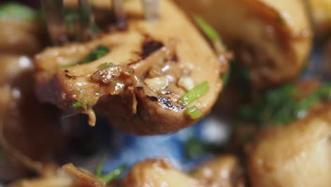 close-up of sauteed mushrooms with fork