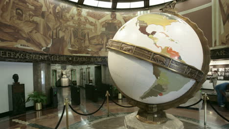 a large globe turns in a museum or planetarium