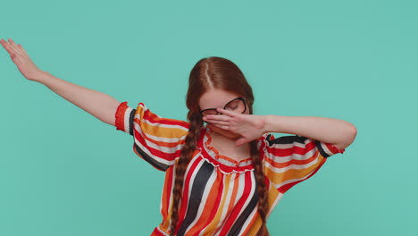 Trendy-cheerful-redhead-girl-dancing-and-moving,-dabbing-raising-hands,-making-dubdance-gesture