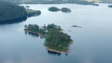 aerial drone view of a small island in peaceful lake