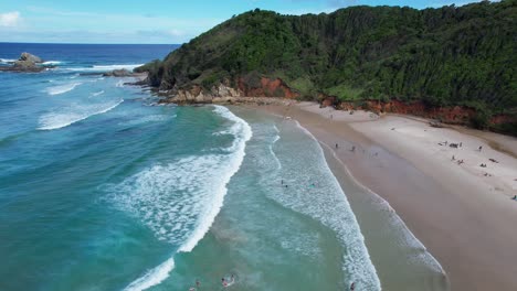 sandy shore of broken head beach in nsw, australia - aerial drone shot