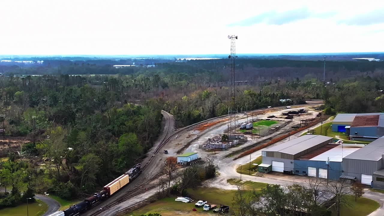 Cargo Train On Rail Tracks At Industrial Zone In Georgia, USA. aerial shot, slow motion