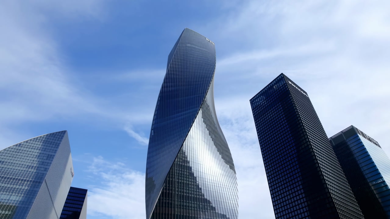 Twisting Glass Skyscraper Against Blue Sky, Futuristic Corporate District With Reflective Facades Catching
