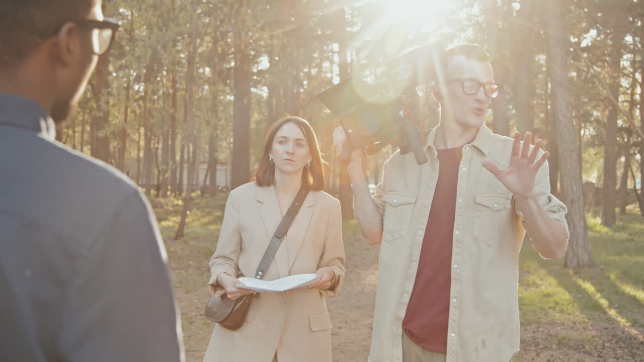 Cameraman Giving Instructions While Shooting Outdoors