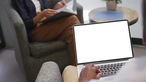 African-american-businessman-using-laptop-for-video-call-with-copy-space