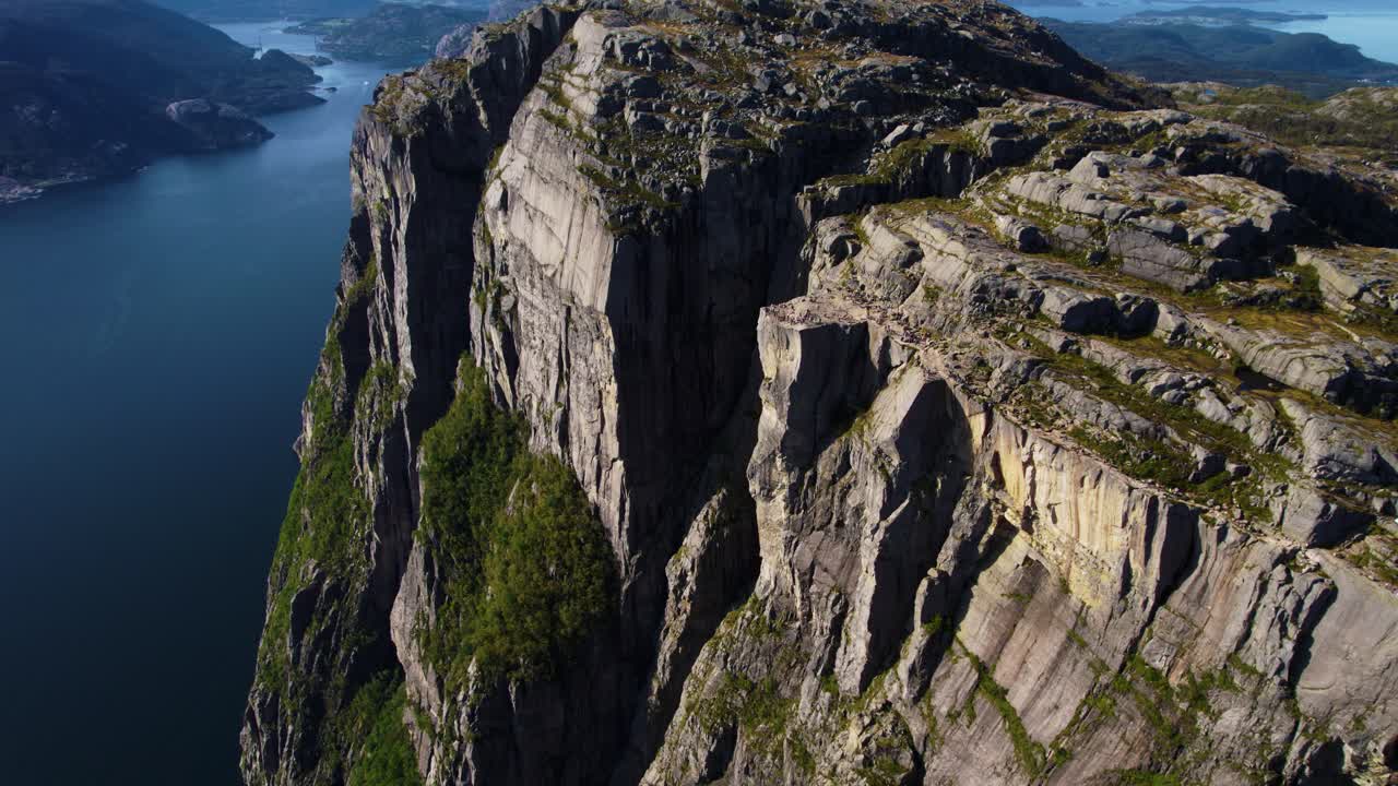 Majestic view of Preikestolen Pulpit Rock, Norway. Surrounded by fjord water and mountain terrain.
