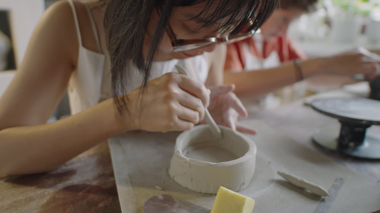 Asian Woman Making Her Own Ceramics at Pottery Workshop