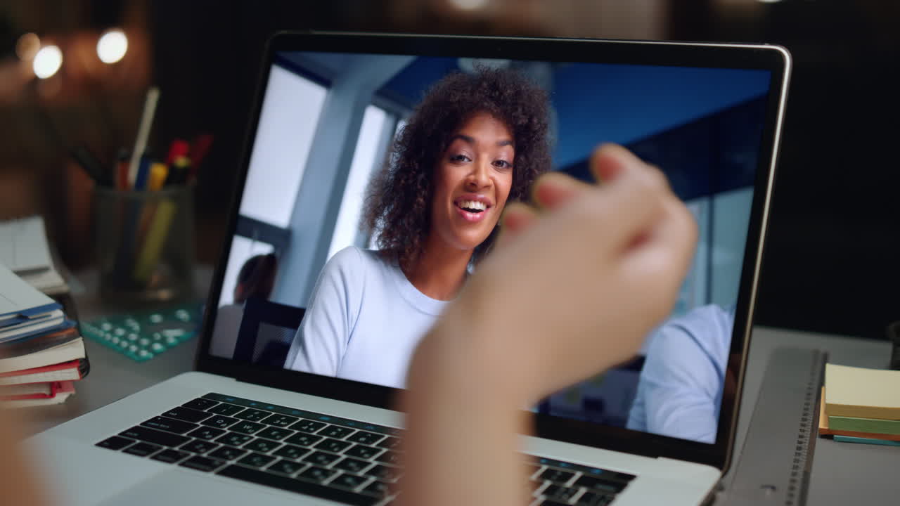Ragazza che parla durante una riunione online con un coach tramite videochiamata su laptop, primo piano in casa