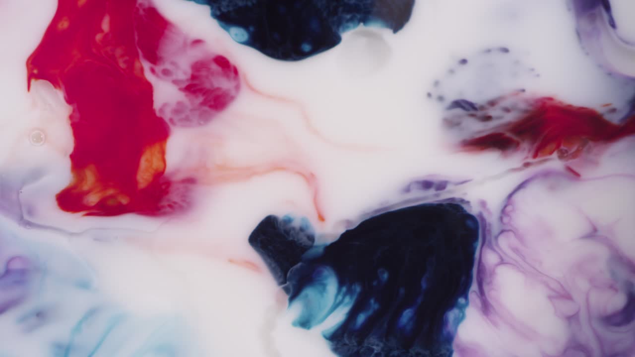 Colorful red blue and purple mixing liquid motion white background