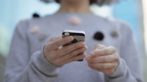 closeup shot of female hands typing message on phone.