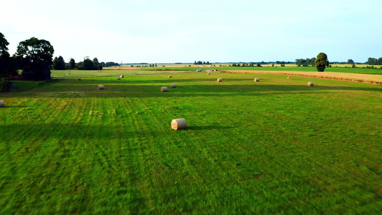 Fly Away At Countryside Field With Hay Bale Rolls During Summer In Lithuania