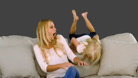 Girl-jumping-above-the-sofa-and-surprising-her-mother-in-slow-motion-