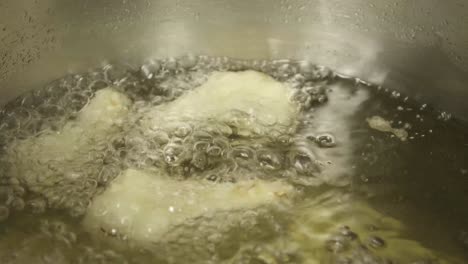 Closeup-shot-at-batter-fried-cauliflower's-in-a-metallic-pan-being-cooked