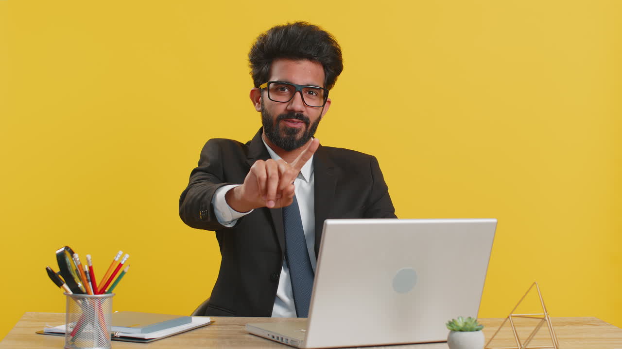 Business man working on laptop shakes finger saying no be careful giving advice to avoid mistake