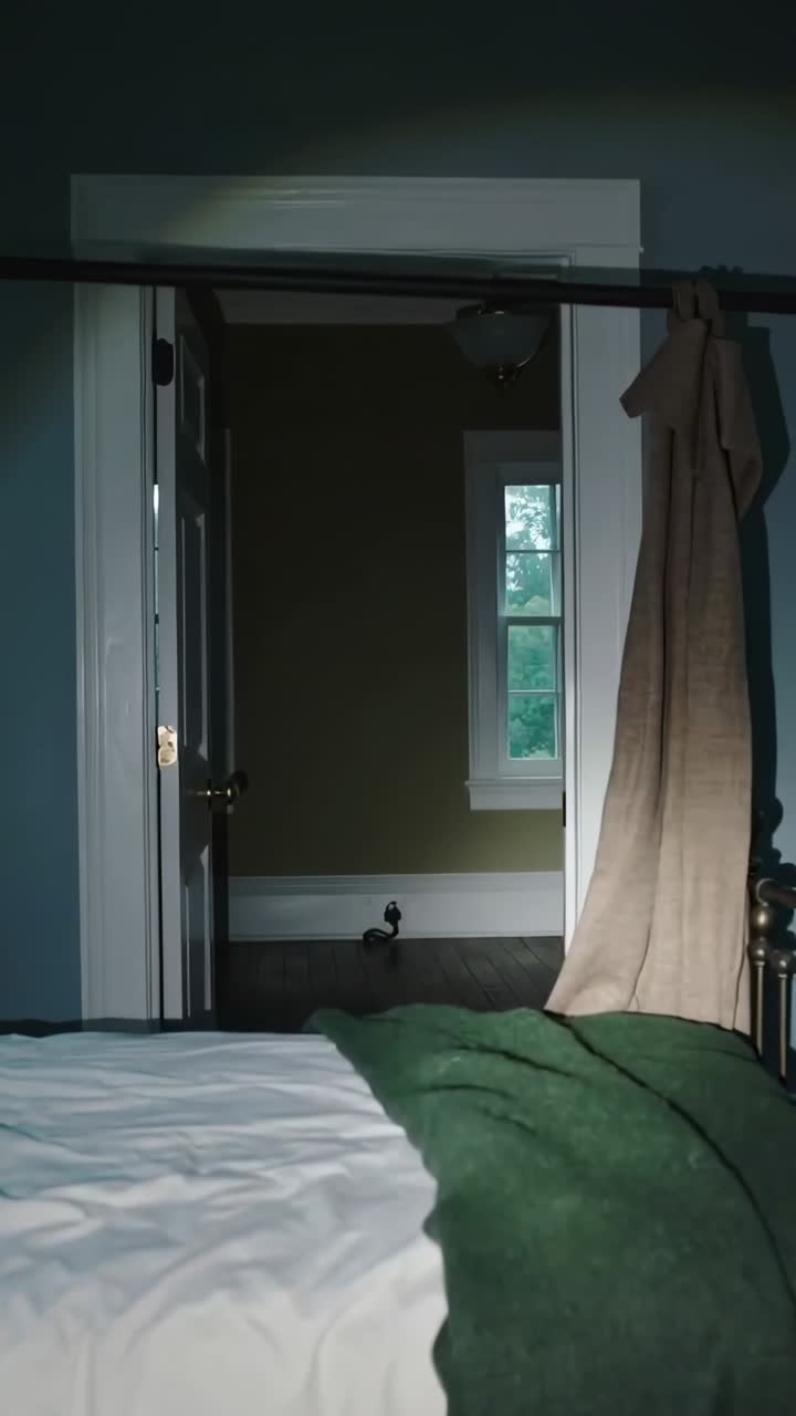 Vertical video: Opening interior door revealing room beyond from bedroom, bed showing small object