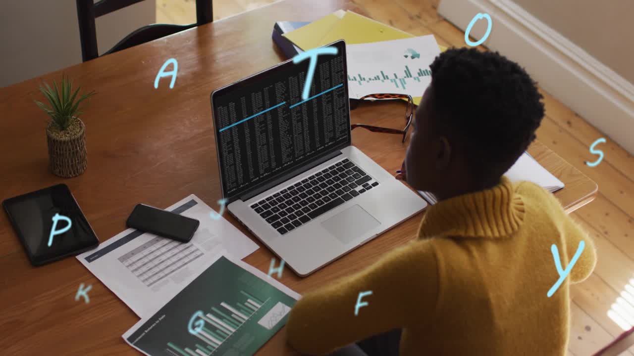 Tech developer leaning over laptop executing code with animated letters multiplying and swirling