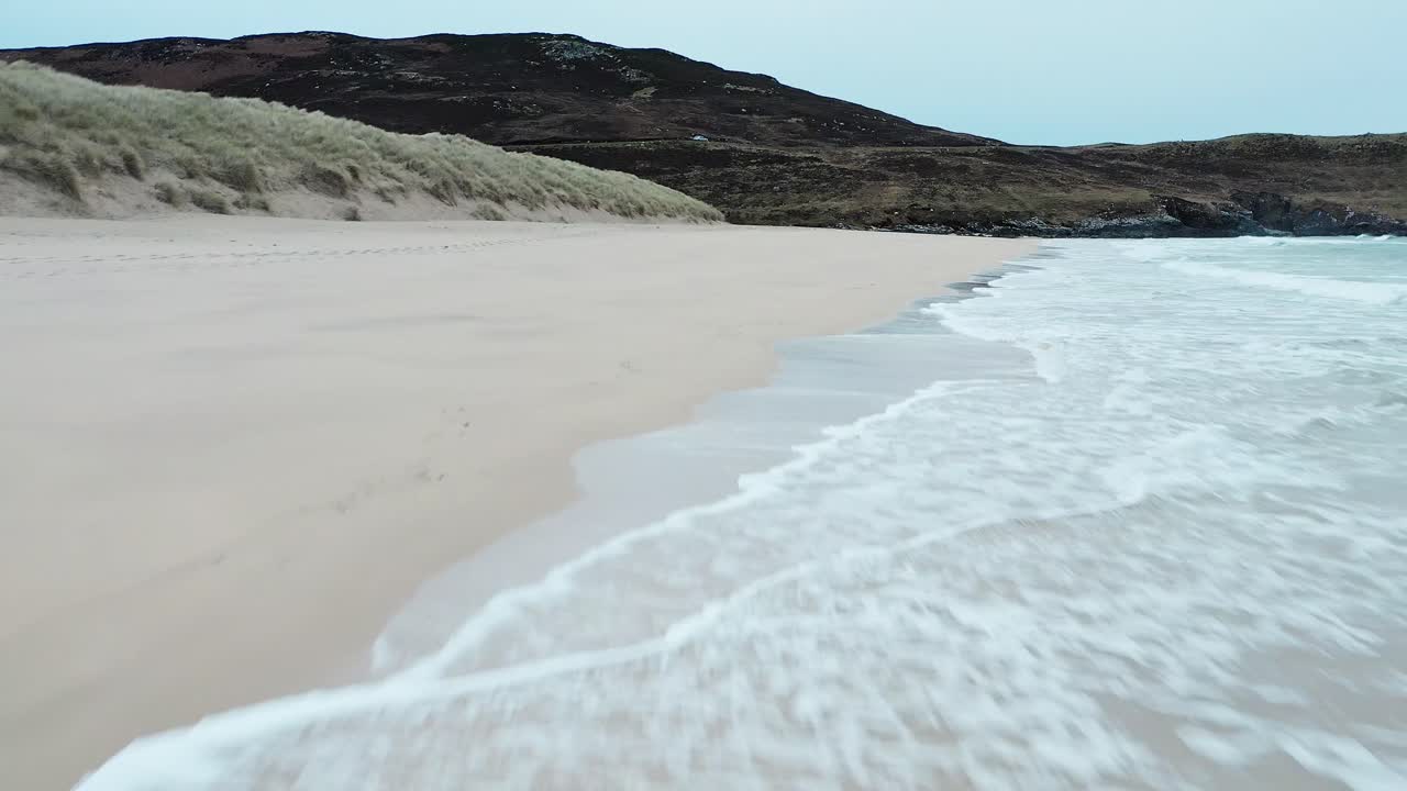 Low flying drone shot capturing the incoming tide on Traigh Mhor beach