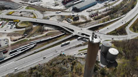 heating plant and highway road in industrial area, aerial tilt down