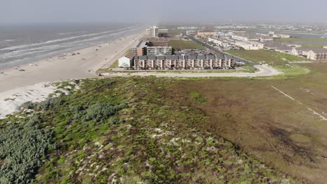 Flying-over-grasslands-and-dunes-moving-towards-condo-complex