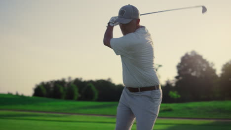 excited golfer playing golf on field. rich senior practicing sport activity game