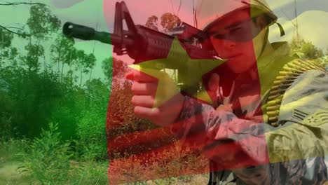 composición digital de ondear la bandera de camerún contra el entrenamiento de soldados con un arma en el campamento de entrenamiento