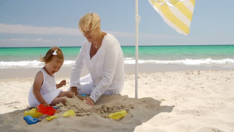 Oma-Und-Kleines-Mädchen-Verbringen-Zeit-Am-Strand