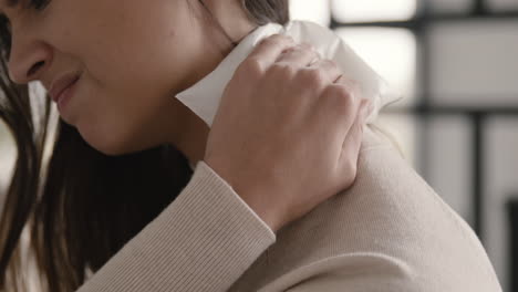 Close-Up-Of-A-Suffering-Woman-Trying-To-Relieve-Neck-Pain-With-An-Ice-Pack-At-Home